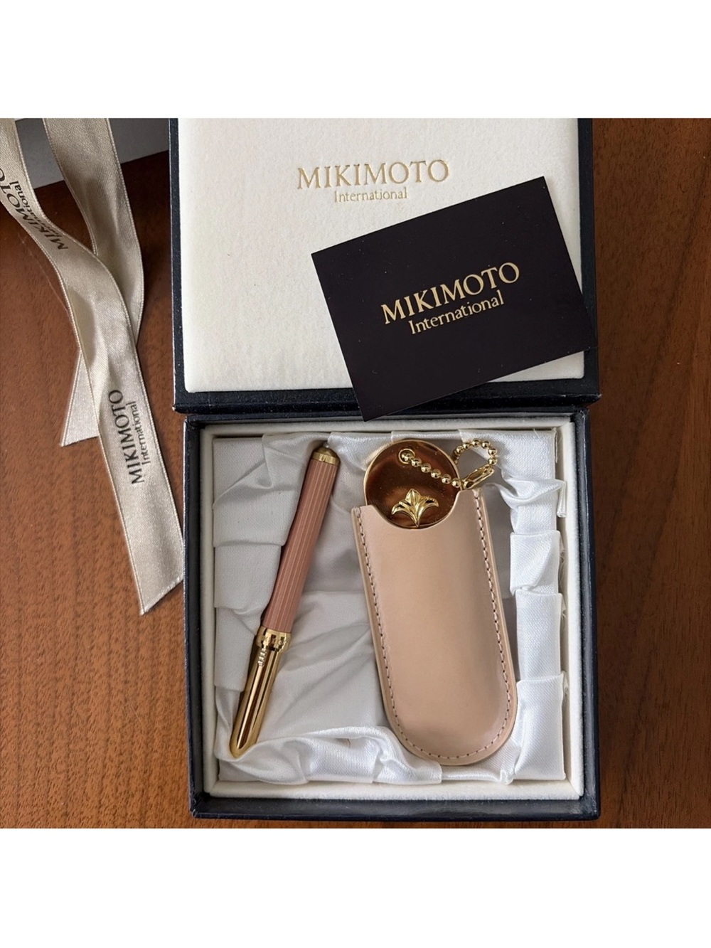Mikimoto lip brush with pearl and mirror in sleeve.  New with gift box.